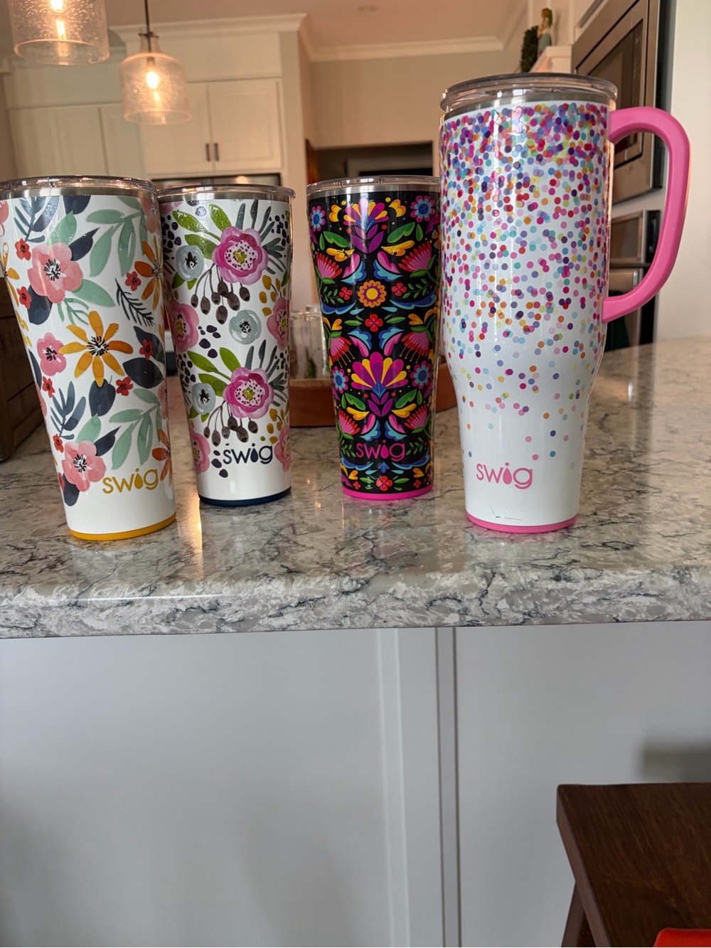 Group of 4 Swig Travel Tumblers with lids.